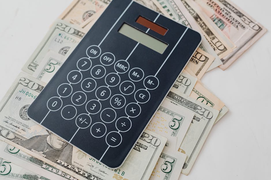 Close-up of a calculator atop US dollar bills, symbolizing financial planning an