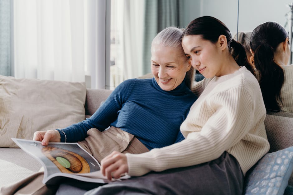 A mother and daughter sharing a joyful moment together on a comfortable couch in