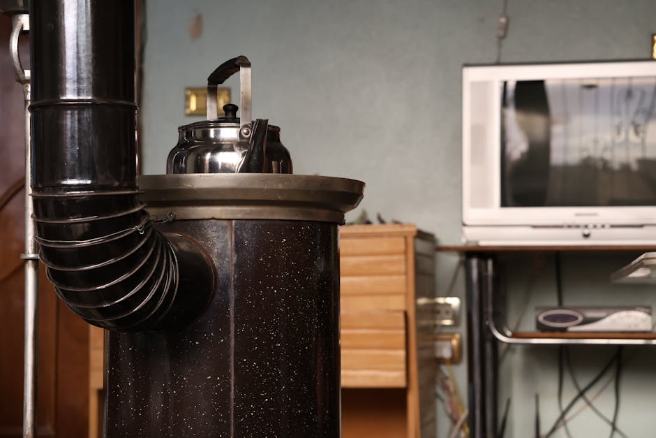 An vintage stove with a kettle beside a retro TV set, creating a nostalgic indoo