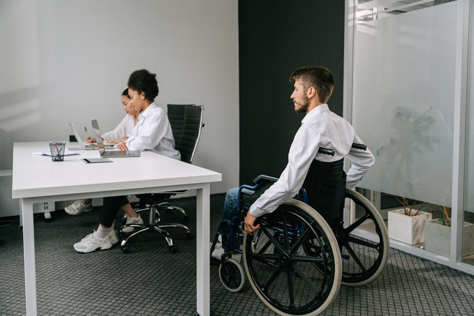 Diverse team in an office meeting, focusing on inclusive workplace and accessibi