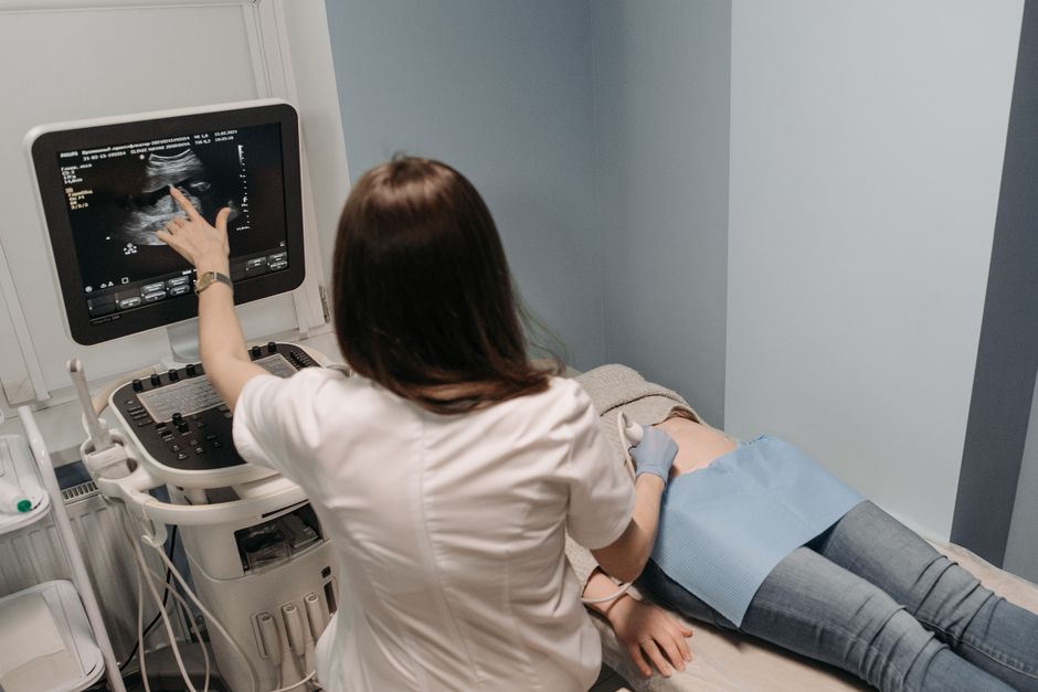 Female doctor conducting an ultrasound screening on a patient in a medical offic