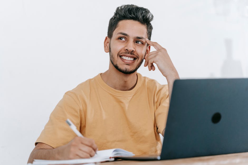 Smiling young bearded Hispanic male entrepreneur thinking over new ideas for sta